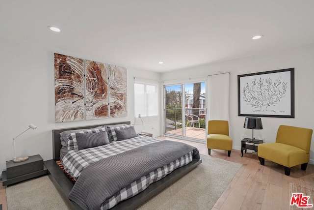 bedroom featuring access to outside and light hardwood / wood-style flooring