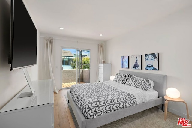 bedroom with light wood-type flooring and access to outside