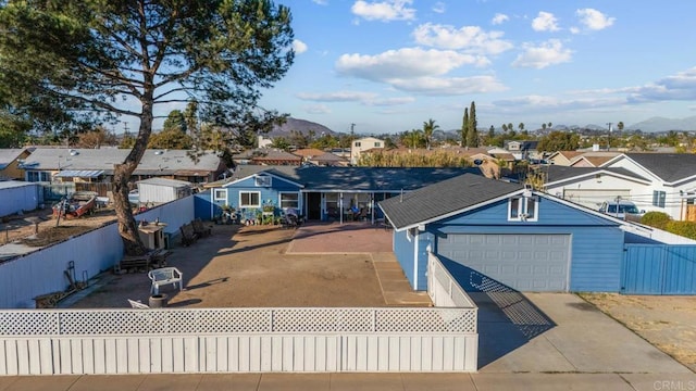 view of front facade with a mountain view and a garage