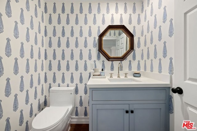 bathroom featuring vanity and toilet