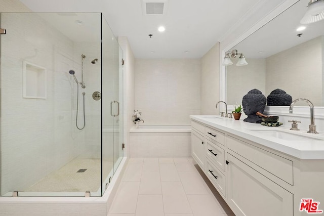 bathroom with tile patterned flooring, vanity, and independent shower and bath