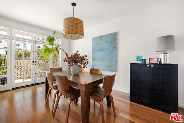 dining space with hardwood / wood-style floors