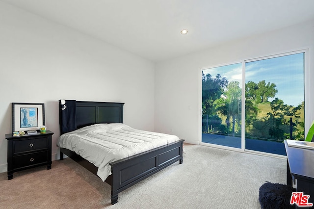 carpeted bedroom with access to outside