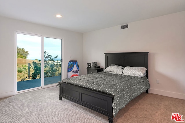 carpeted bedroom featuring access to outside