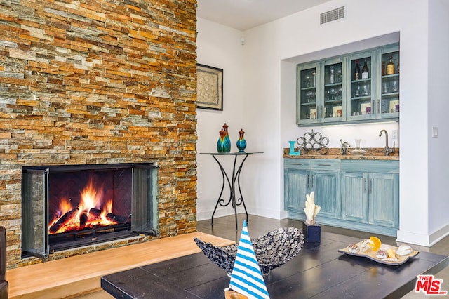 interior space with a stone fireplace and sink