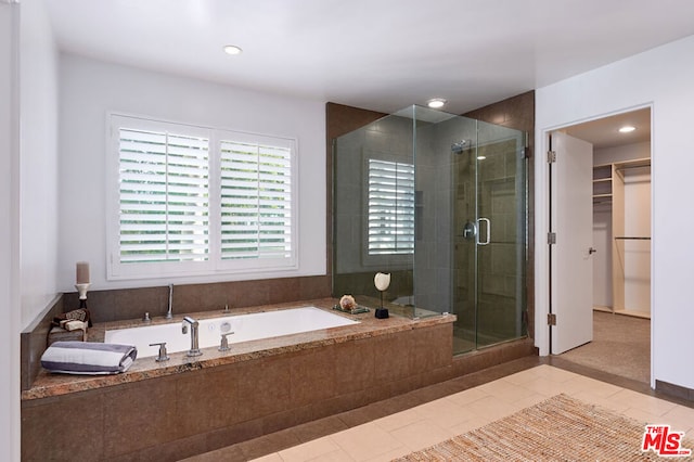 bathroom with tile patterned flooring and plus walk in shower