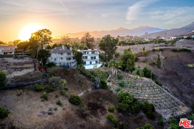 aerial view at dusk featuring a mountain view