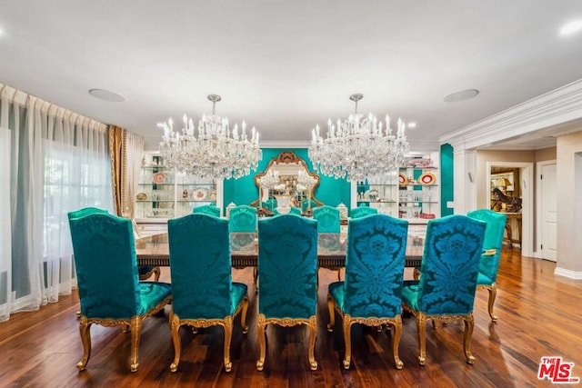 dining room with hardwood / wood-style flooring, ornamental molding, and a chandelier