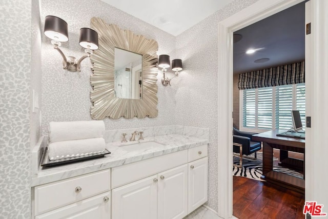 bathroom featuring vanity and hardwood / wood-style flooring