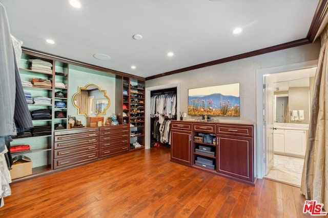 interior space featuring ornamental molding, dark wood-type flooring, and sink