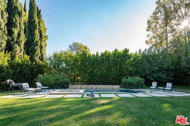 surrounding community featuring a yard and a patio