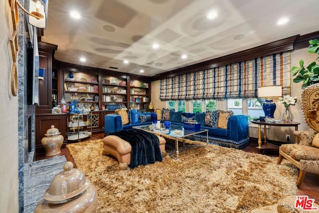 living area with built in shelves and dark hardwood / wood-style flooring