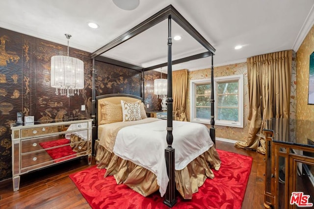 bedroom with dark hardwood / wood-style flooring, crown molding, and a chandelier