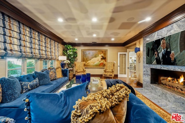 home theater featuring crown molding and a fireplace