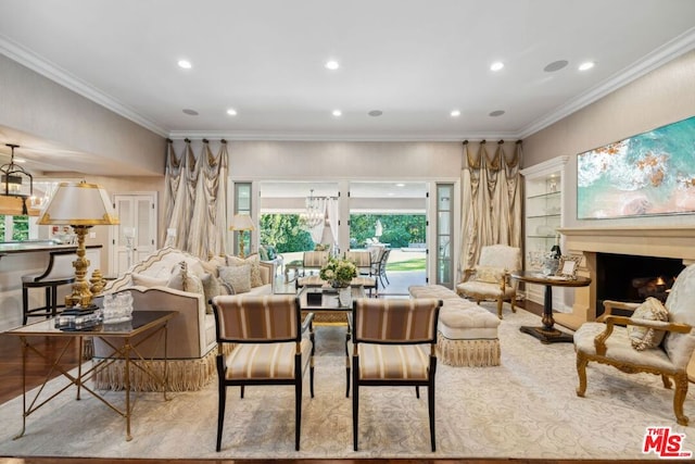 living room featuring an inviting chandelier and crown molding