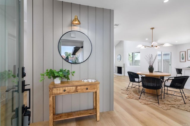 interior space featuring light hardwood / wood-style flooring and a chandelier