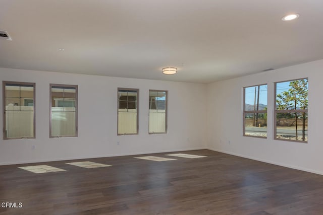 spare room with dark hardwood / wood-style flooring