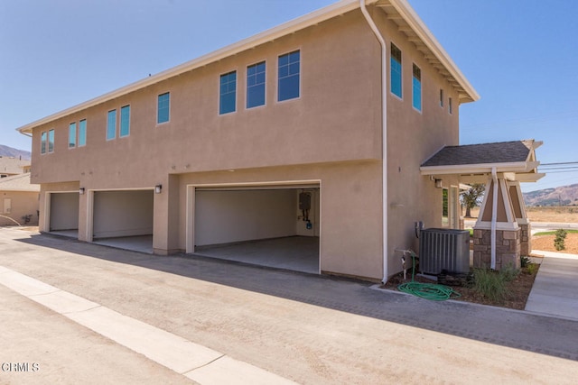 view of front of house featuring cooling unit and a garage