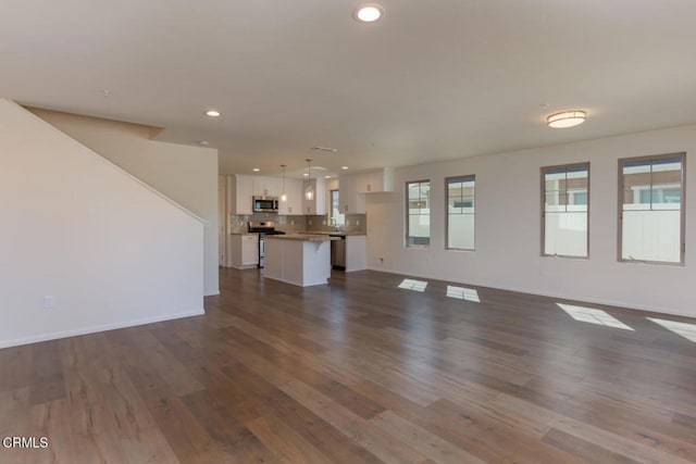 unfurnished living room featuring dark hardwood / wood-style flooring