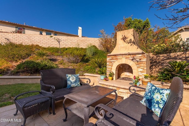 view of patio with an outdoor stone fireplace