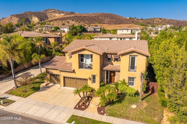 mediterranean / spanish home with a mountain view and a balcony