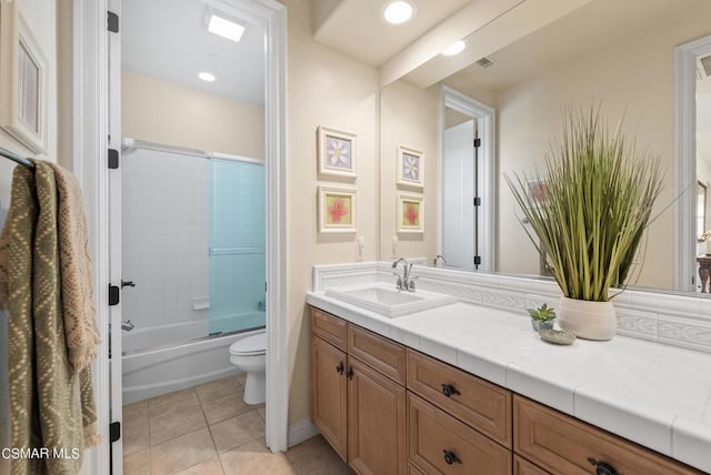 full bathroom with tile patterned floors, vanity, toilet, and enclosed tub / shower combo