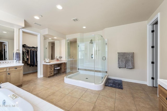 bathroom with vanity, tile patterned floors, and walk in shower