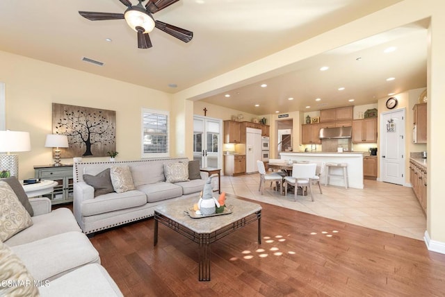 living room featuring ceiling fan and light tile patterned floors