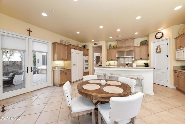 dining space with light tile patterned floors and sink