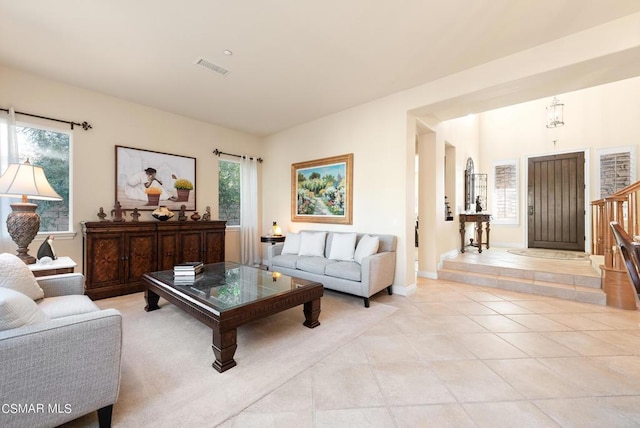 living room featuring light tile patterned floors and a healthy amount of sunlight