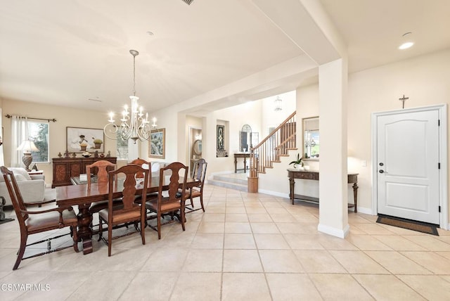 tiled dining space featuring a notable chandelier