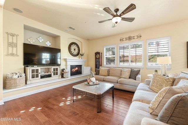 living room featuring hardwood / wood-style flooring and ceiling fan