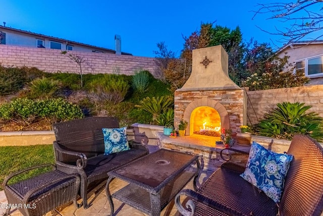 view of patio / terrace featuring an outdoor stone fireplace