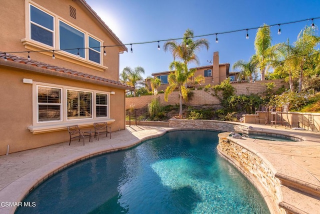 view of swimming pool with an in ground hot tub and a patio