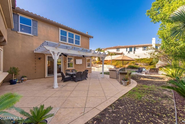 rear view of property featuring a pergola and a patio