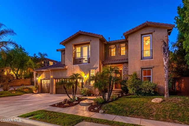 mediterranean / spanish-style home with a balcony and a garage