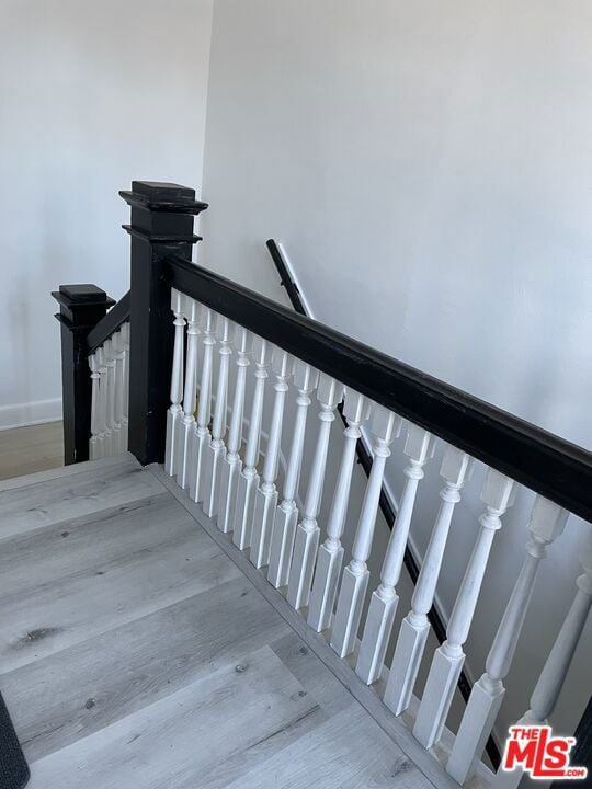 stairs with hardwood / wood-style flooring