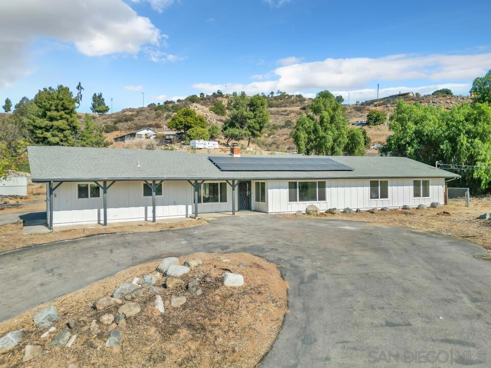 ranch-style house with solar panels