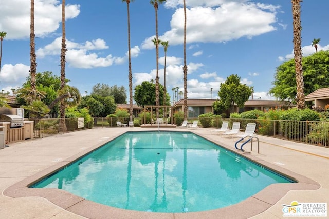 view of pool with a grill and a patio