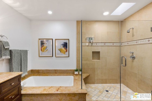 bathroom featuring vanity, a skylight, and plus walk in shower