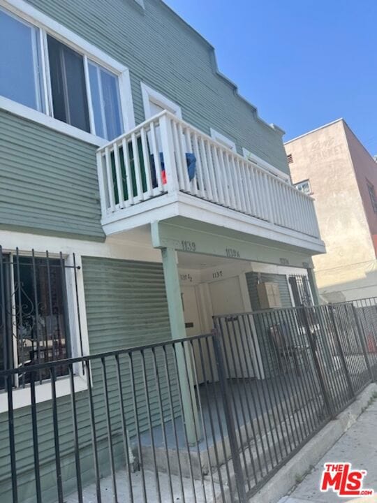 view of side of property featuring a balcony