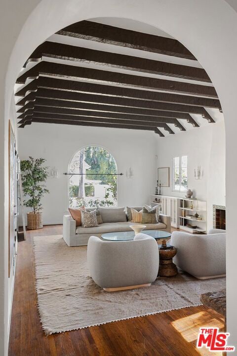 living room with hardwood / wood-style floors and beamed ceiling