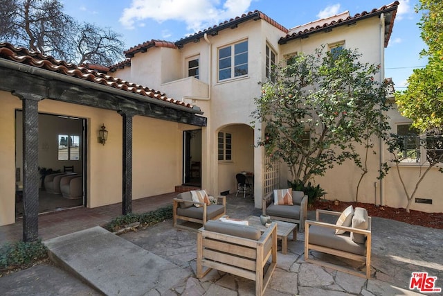 rear view of house with a patio area and an outdoor hangout area