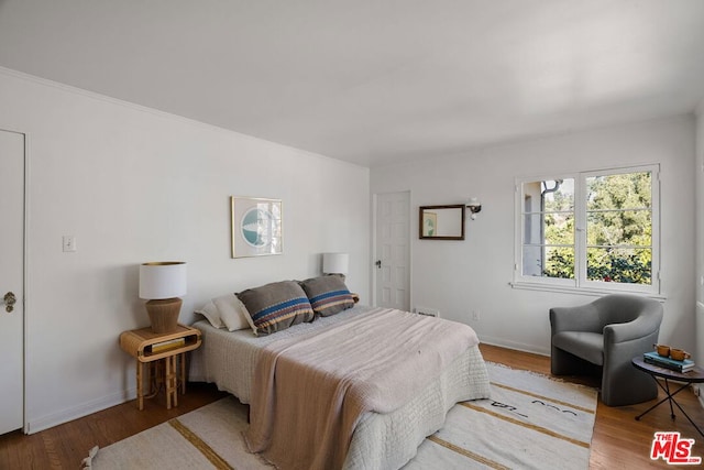 bedroom featuring wood-type flooring