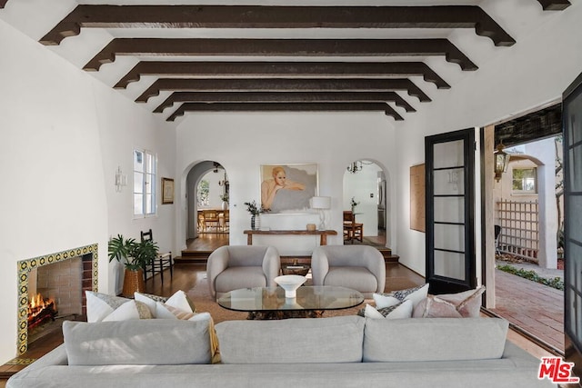 living room with vaulted ceiling with beams and dark wood-type flooring