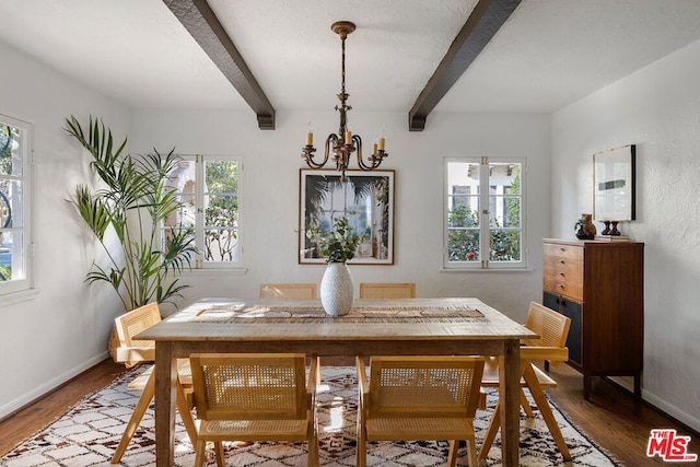 dining space with plenty of natural light, beamed ceiling, wood-type flooring, and an inviting chandelier