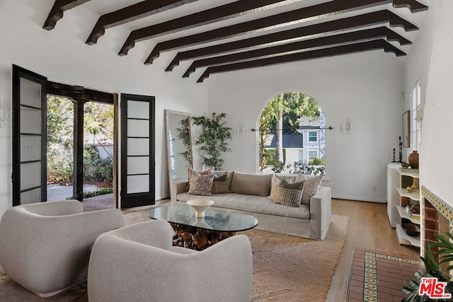 living room with beam ceiling and light wood-type flooring