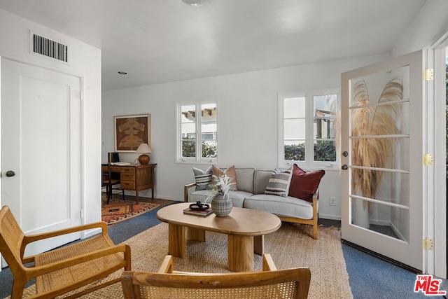 carpeted living room featuring french doors