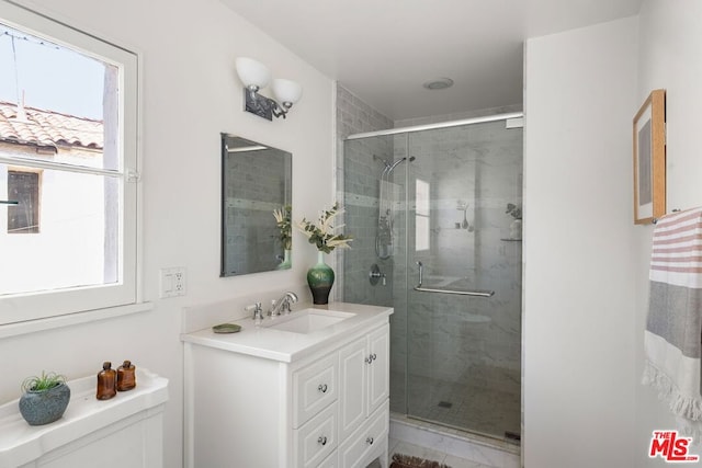 bathroom with plenty of natural light, vanity, a shower with shower door, and toilet