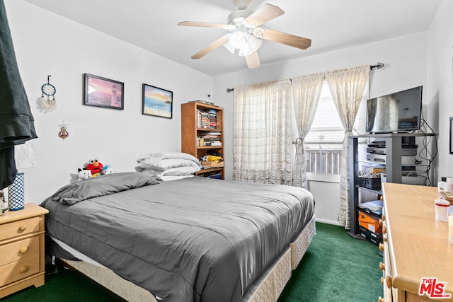 bedroom featuring dark colored carpet and ceiling fan